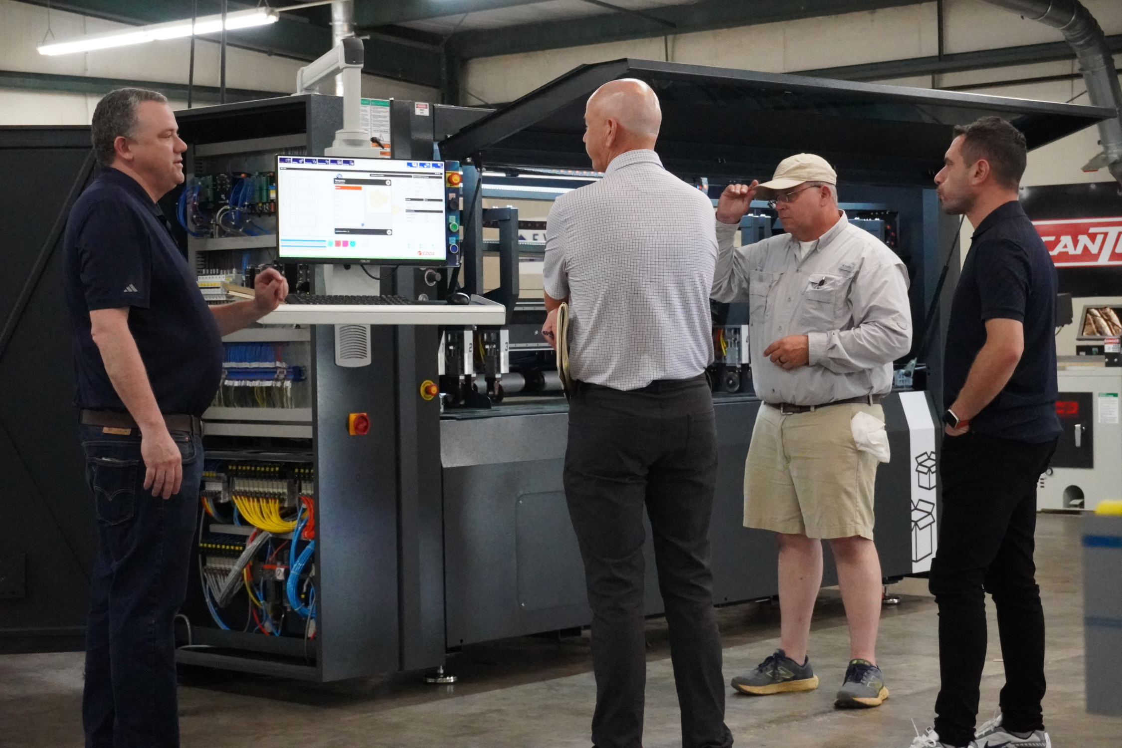 Atlantic Tape and Packaging team with an Edda representative reviewing the Right Choice Box Machine